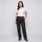Woman wearing the Black women's rain trousers with a white t-shirt and walking boots, full length
