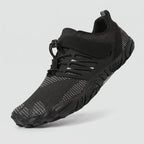 Black barefoot shoe at a three-quarter angle showing the wide toe box, strap and quick-pull lace