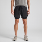 Man wearing the Black 2 in 1 running shorts, front view with running shoes