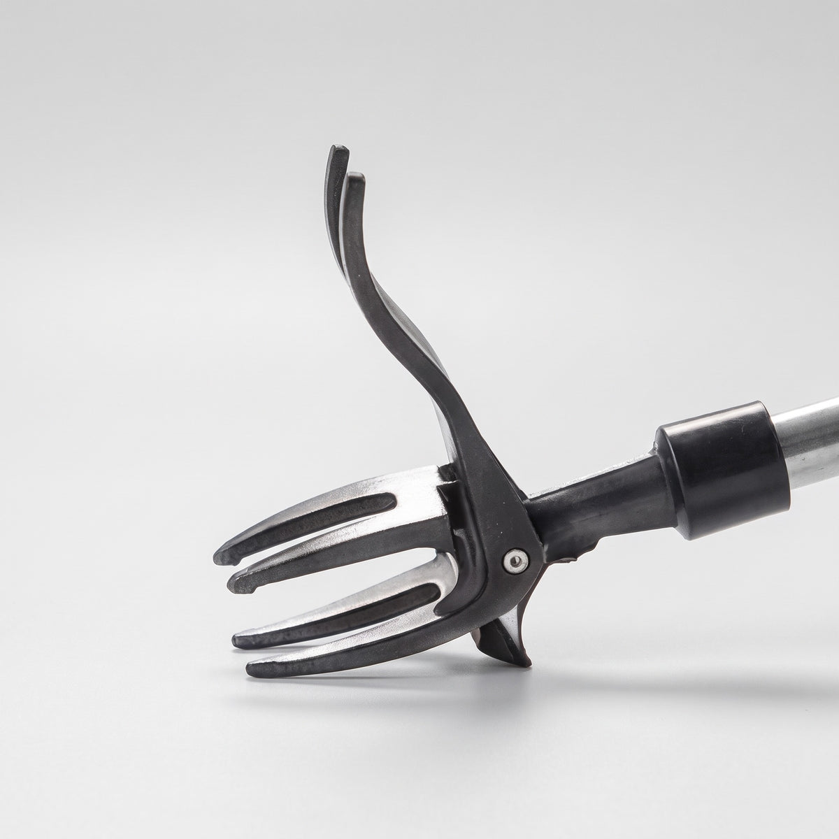 Close-up of the four-claw steel head and curved foot pedal