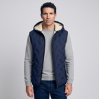 Man wearing the navy hooded gilet over a grey jumper