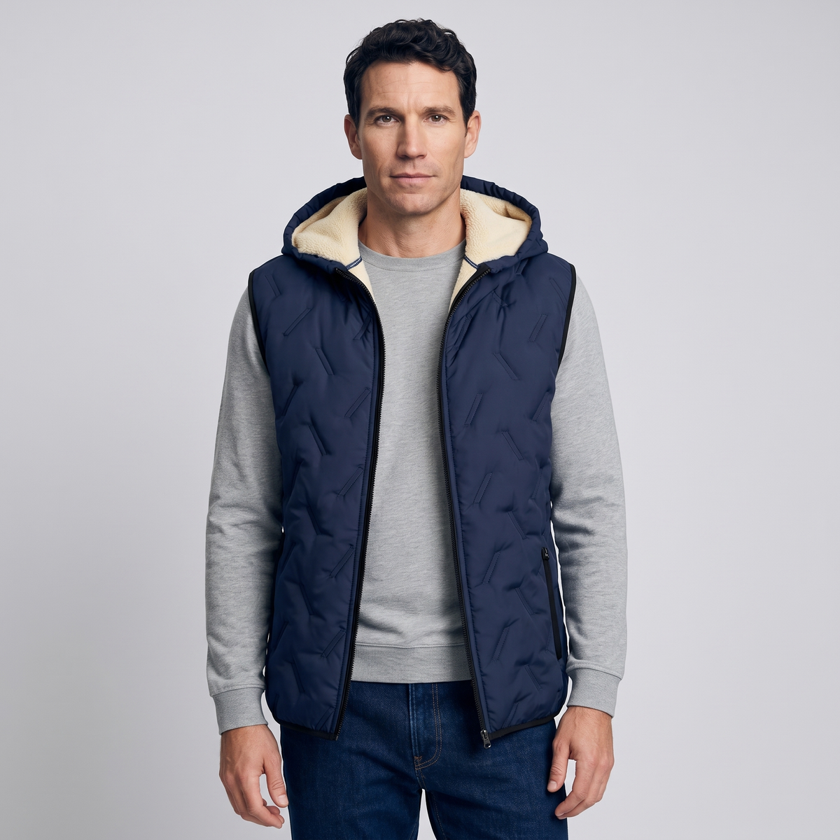 Man wearing the navy hooded gilet over a grey jumper