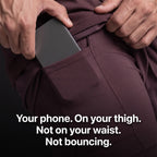 A phone sliding into the phone pocket on the compression liner thigh