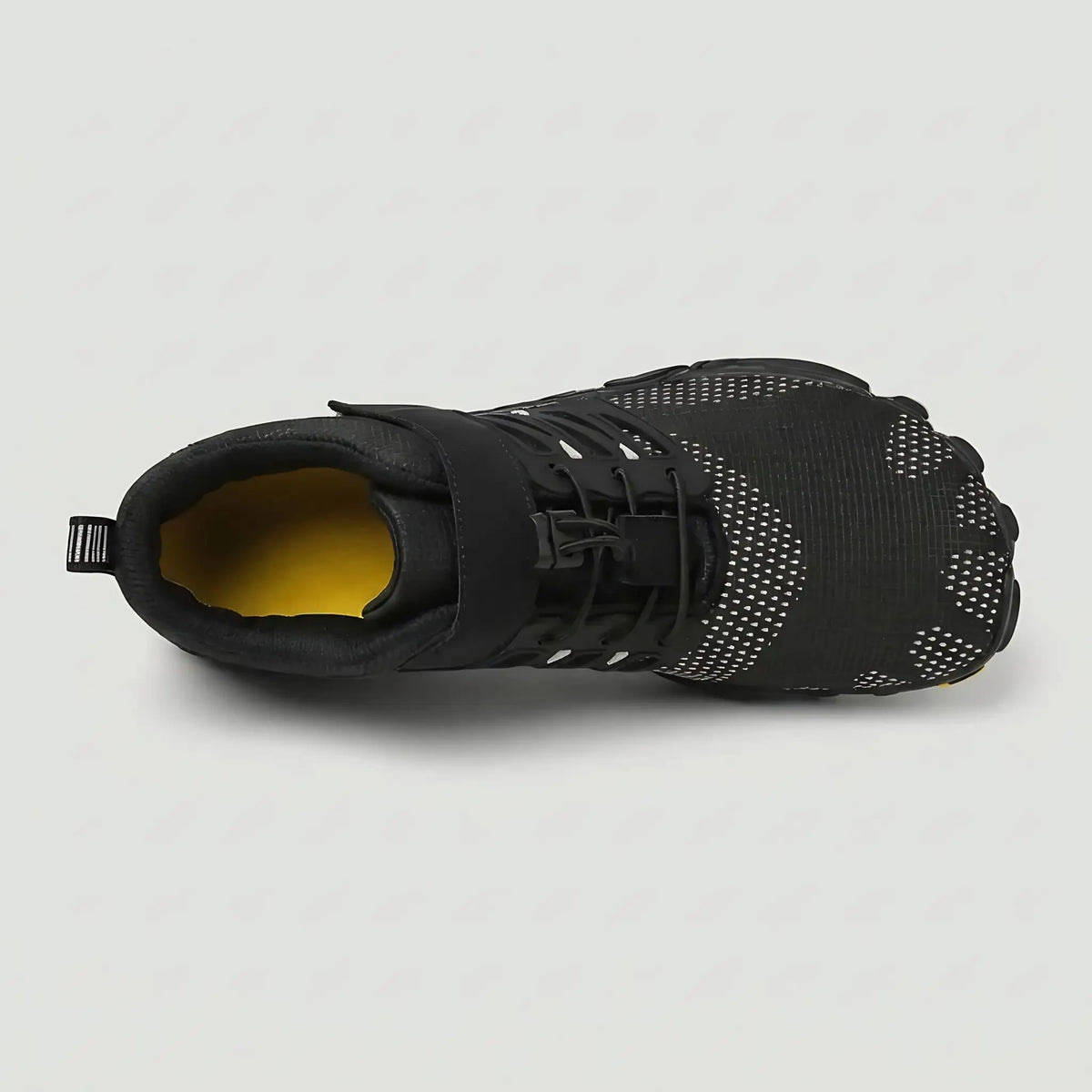Black barefoot shoe from above showing the wide foot-shaped toe box
