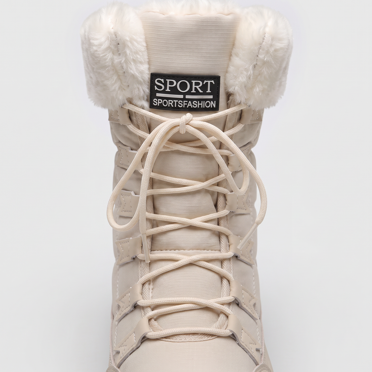 Lace-up front of the snow boot with laces through stitched loops