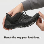 Hands bending the barefoot shoe to show the thin flexible sole