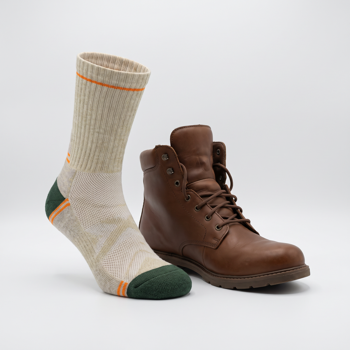 The sock standing beside a walking boot, the crew cuff finishing above the boot collar