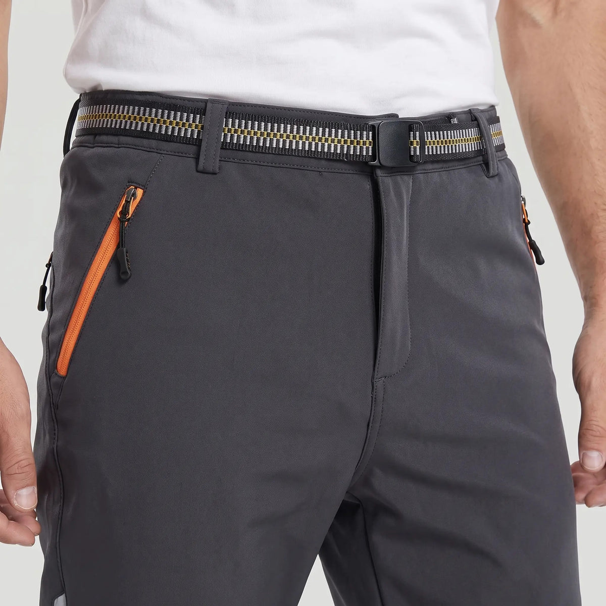 Men's fleece lined walking trousers, close-up of the webbing belt, buckle and zipped pocket