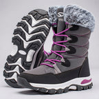 Grey women's snow boots with the deep chevron tread outsole shown