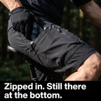 Phone going into the zipped cargo pocket of the MTB shorts on the bike
