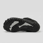 Lugged rubber outsole of the black barefoot shoe with contrast insert