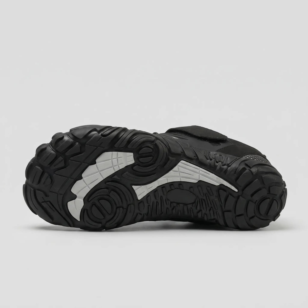 Lugged rubber outsole of the black barefoot shoe with contrast insert