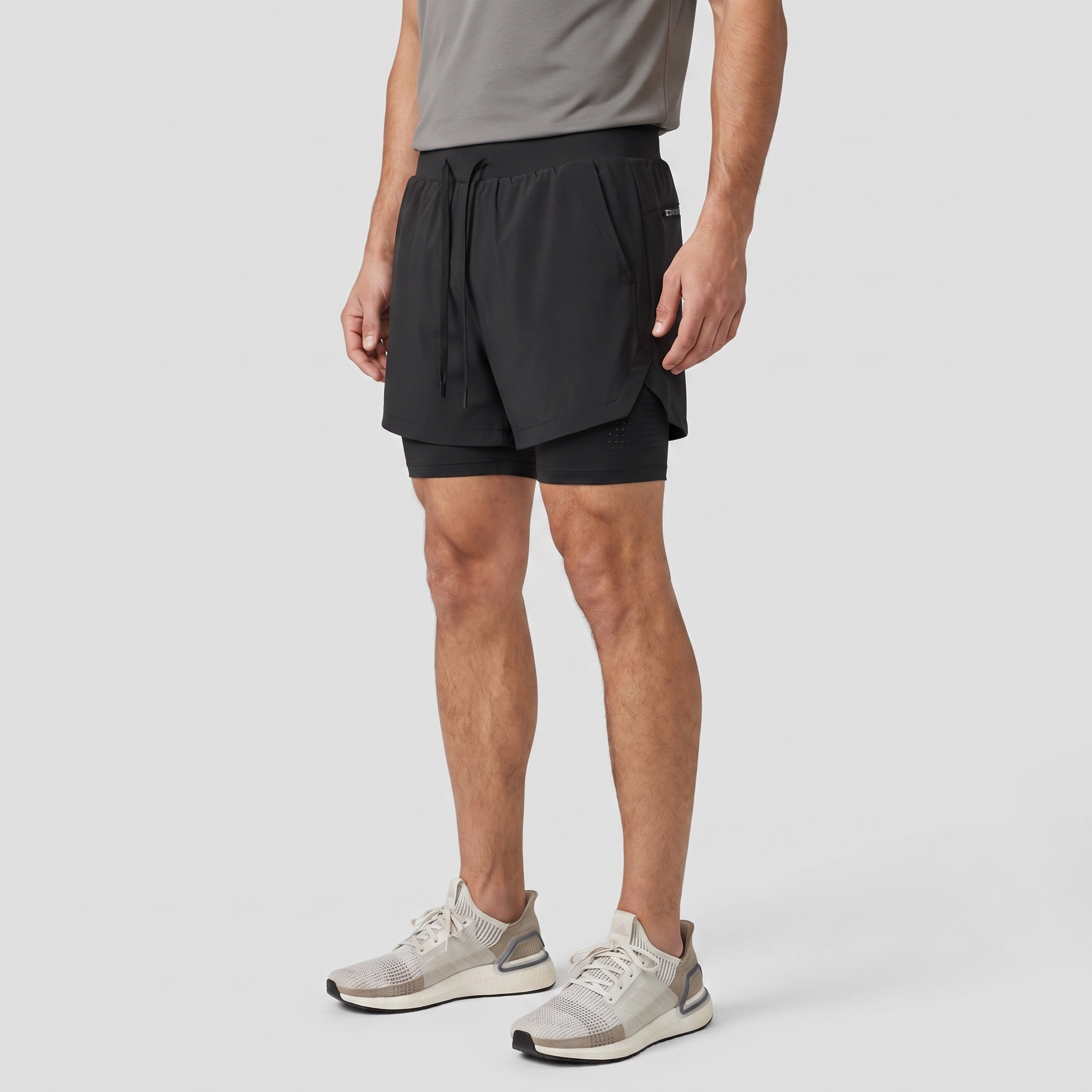 Three-quarter side view of the Black 2 in 1 running shorts showing the split vented hem