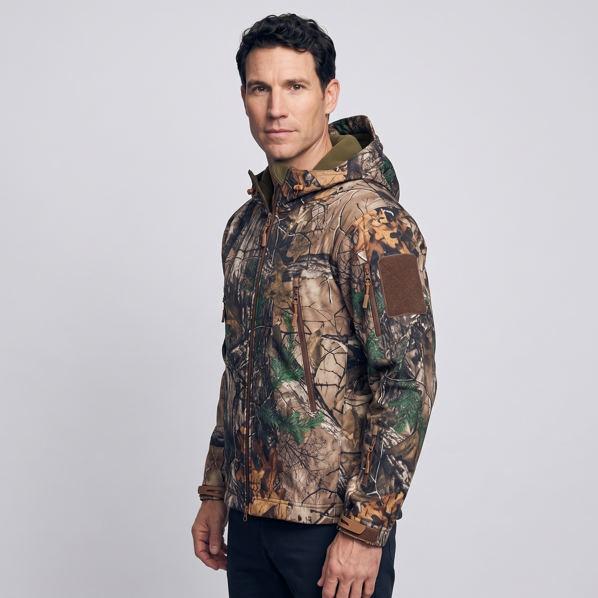 Side view of the Leaf Camo jacket showing the sleeve zip pocket and patch panel