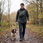 Man walking a dog wearing the bum bag across his body