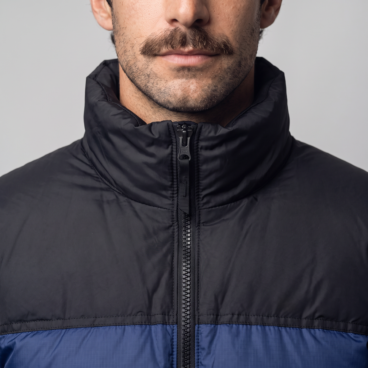 Tall padded stand collar zipped up under the chin on the men's puffer jacket