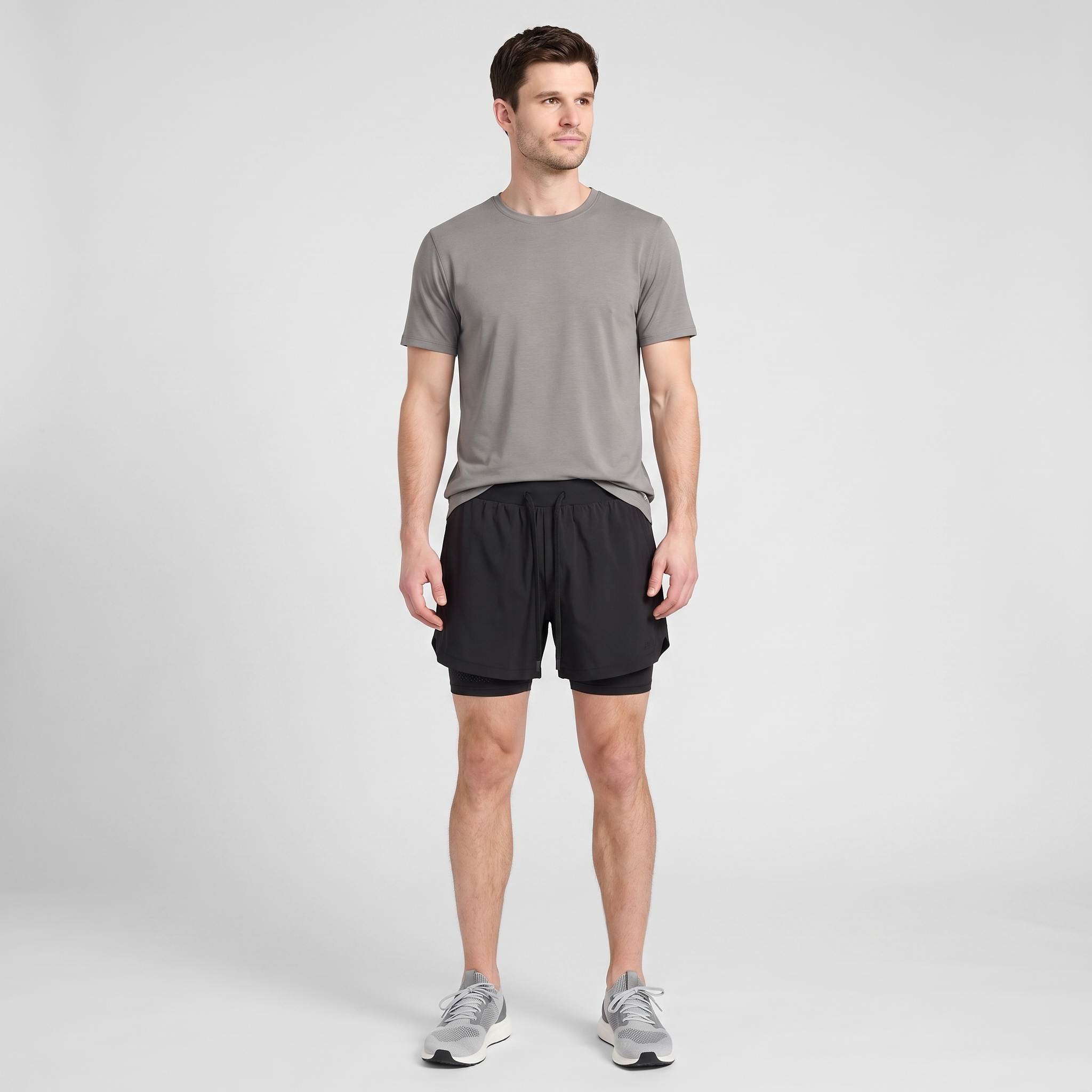 Full length view of a man wearing the Black 2 in 1 running shorts