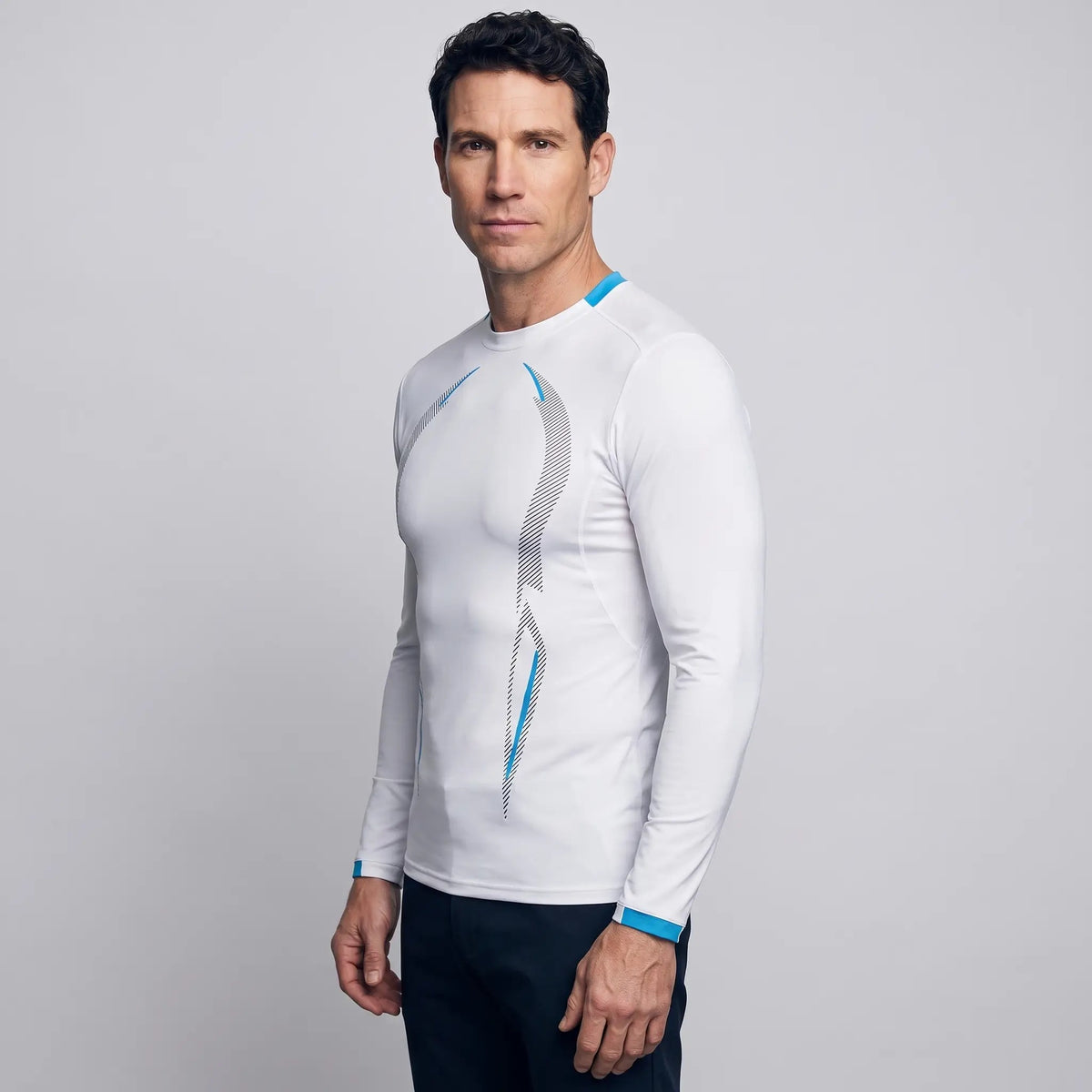 Man wearing the long sleeve running top in White, three-quarter side view