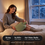 Woman sliding a hot water bottle under the duvet on a winter evening