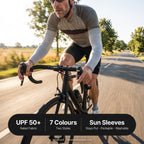 Cyclist wearing UPF 50+ arm sleeves on an open road