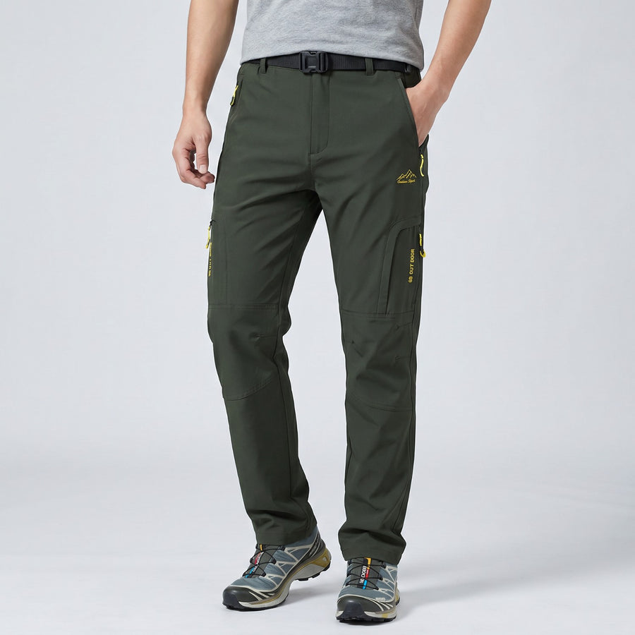 Stepping up in the army green Terrabound Hiking Trousers, knee bent, nothing pulling