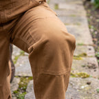 Double layer of canvas across the knee of the dungarees, shown on a bent knee