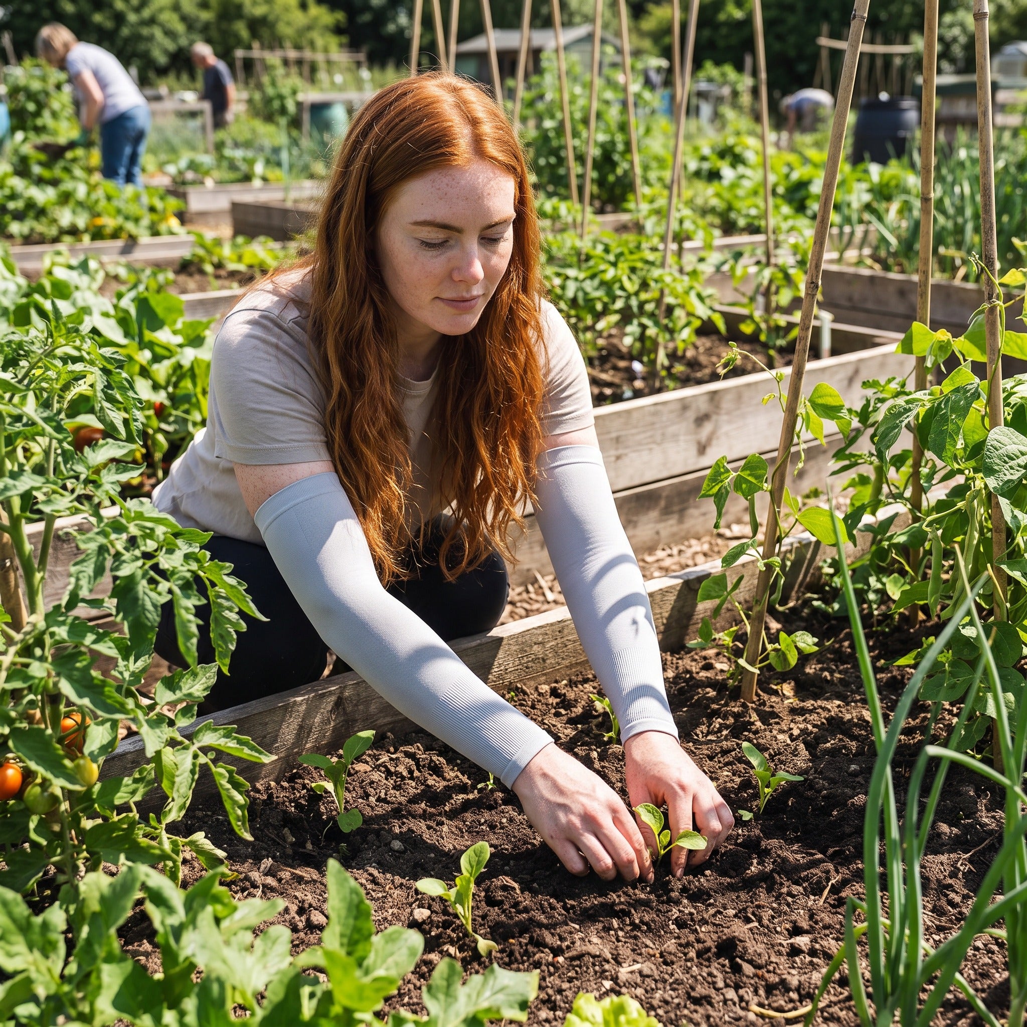 Gardener wearing UPF 50+ arm sleeves planting on an allotment
