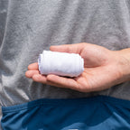 Pair of arm sleeves rolled small in the palm of a hand