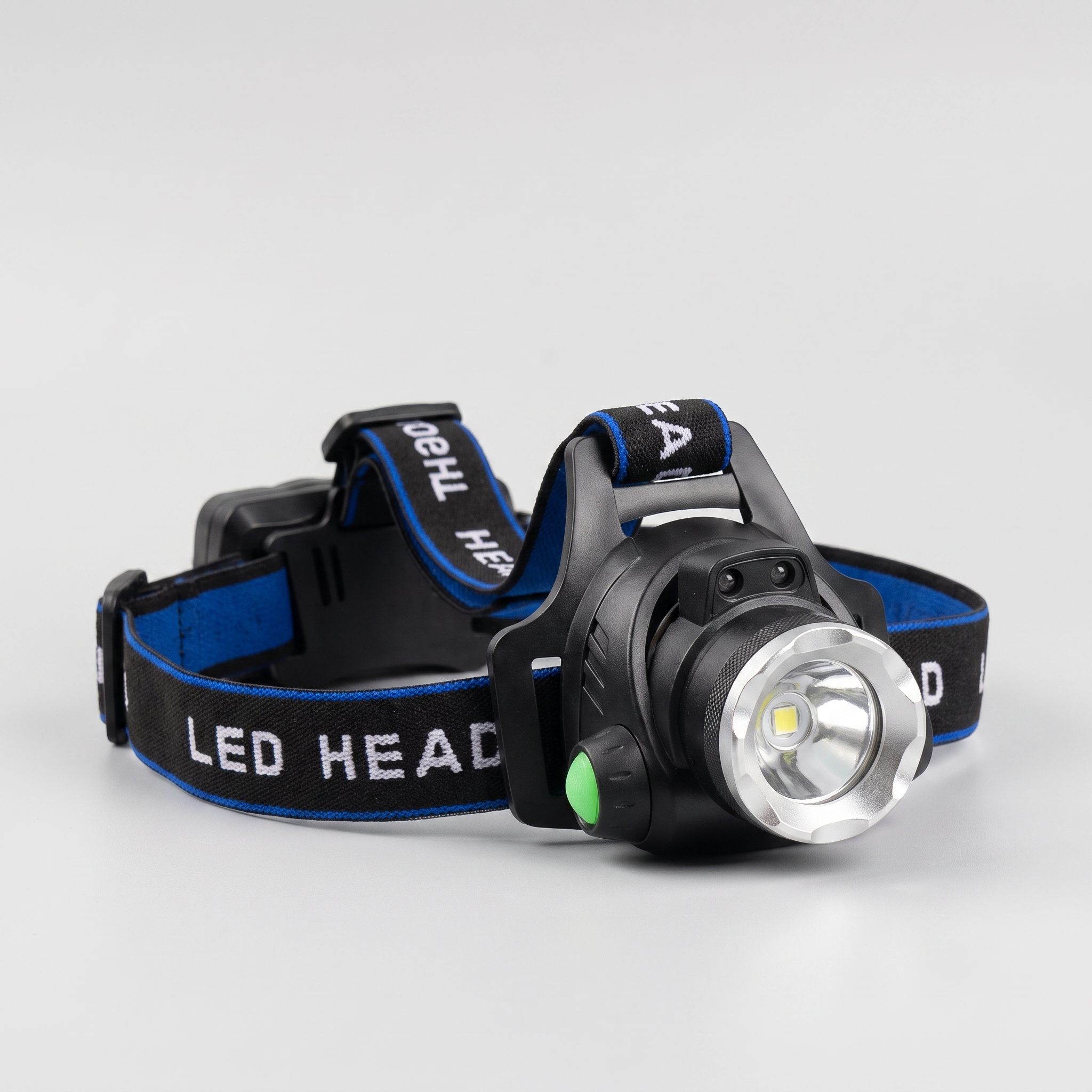 LED head torch with blue and black adjustable webbing harness, front view