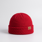 Red ribbed fisherman beanie with a turned cuff and leather label