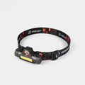 USB rechargeable head torch with a wide COB flood bar and round spot LED on a printed LED HEADLIGHT headband, three-quarter view
