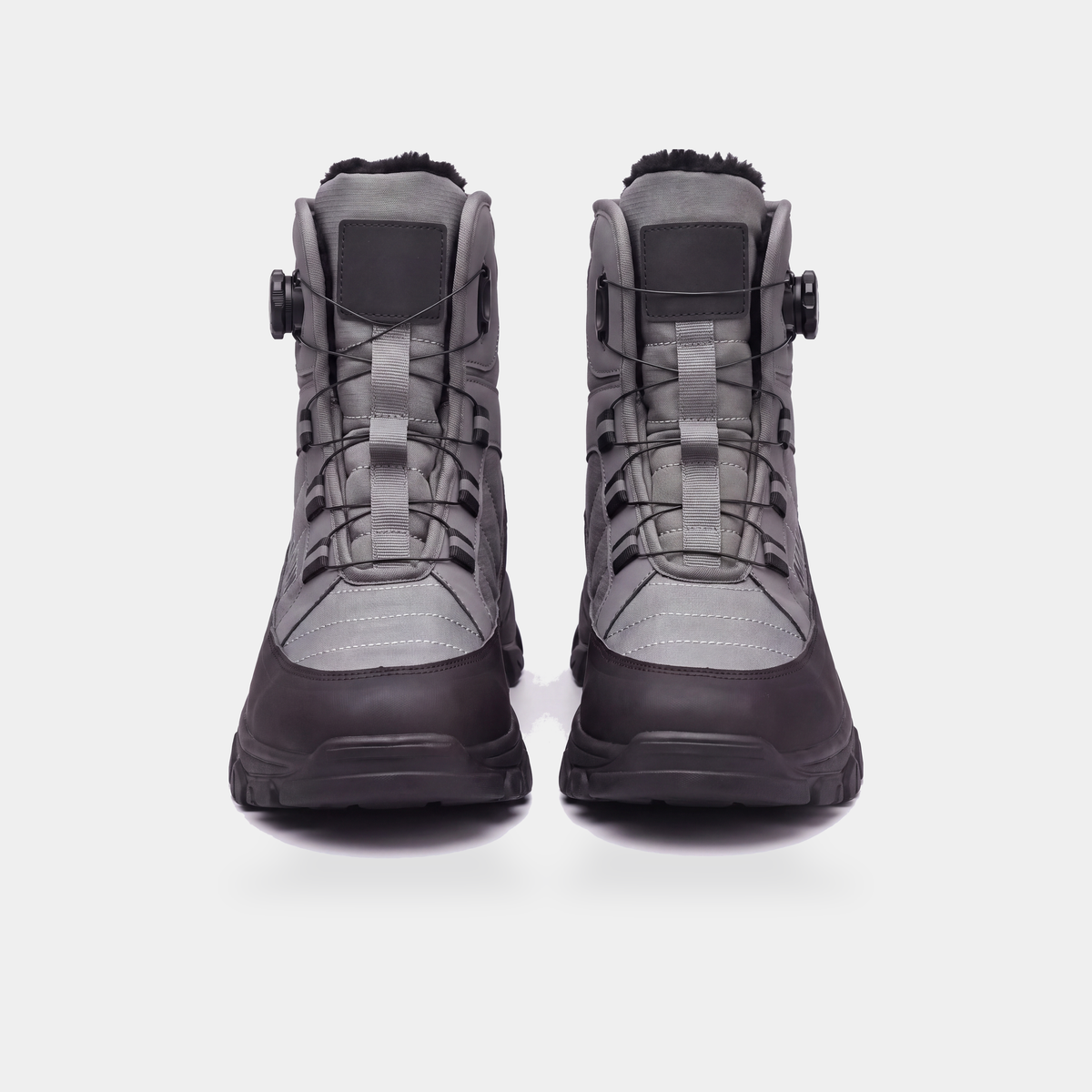 Straight-on front view of the snow boots showing both rotary dials and the full shaft height