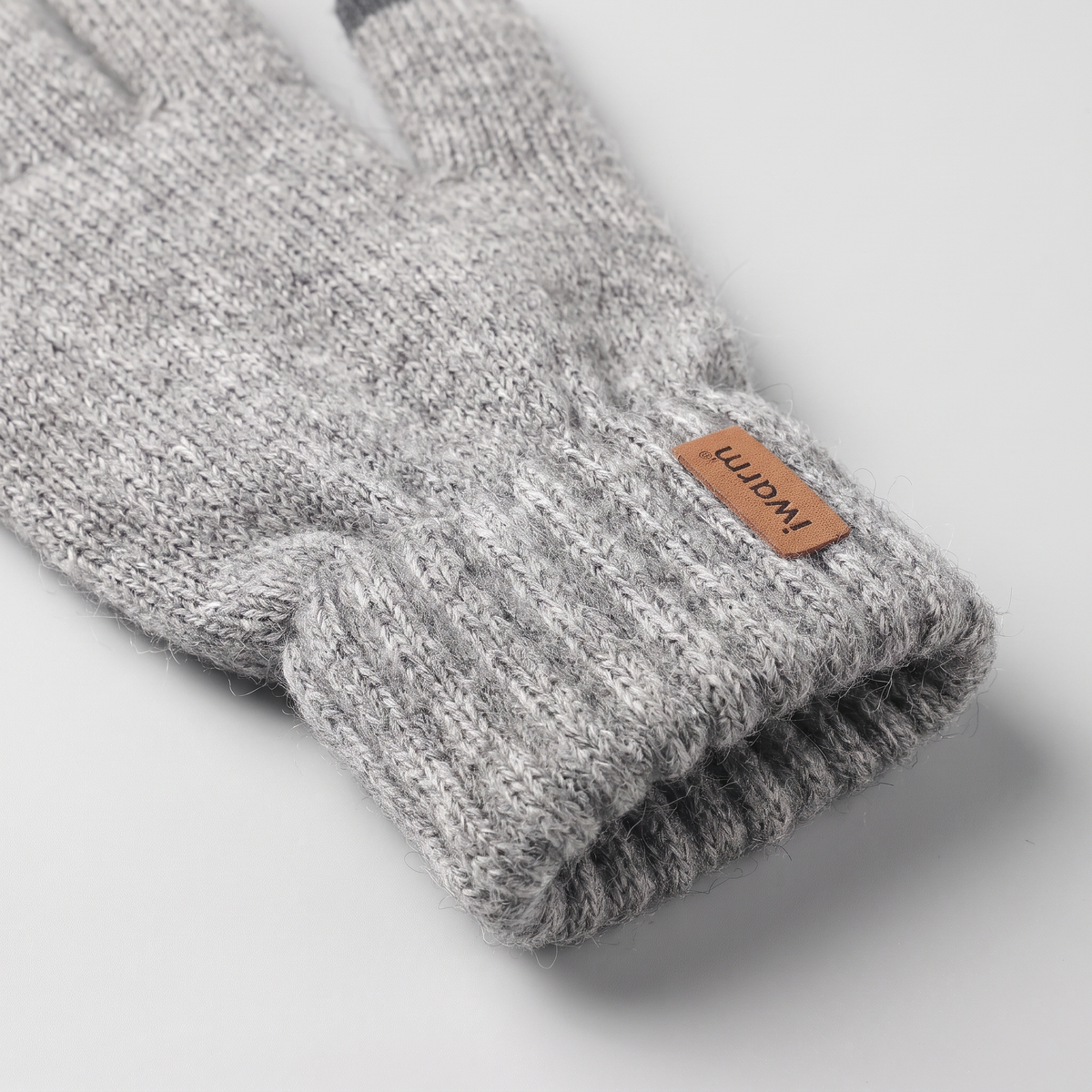 Close-up of the soft brushed knit and deep ribbed cuff with the leather iwarm tab