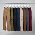 All eight colourways of the walking trousers hanging on a rail