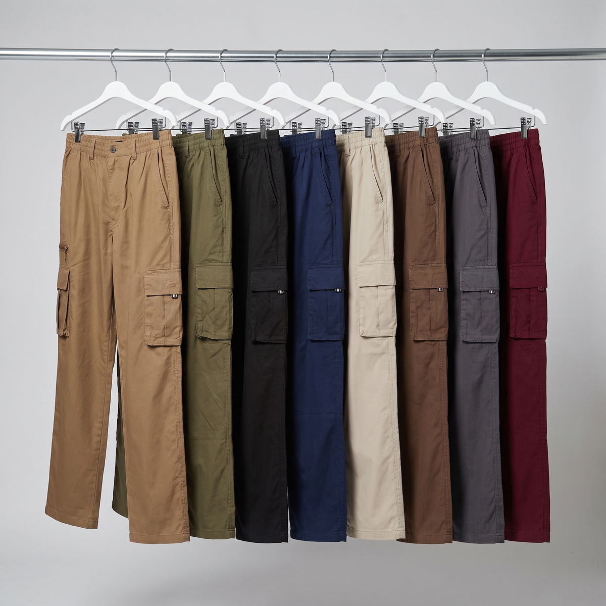All eight colourways of the walking trousers hanging on a rail