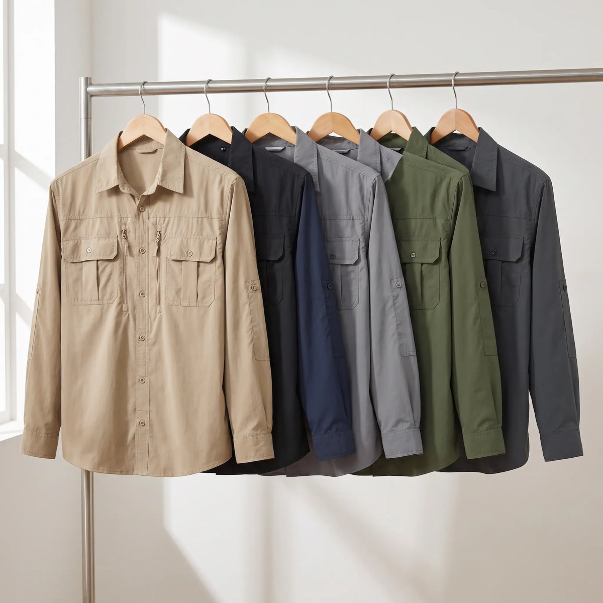 Men's fishing shirt in all six colours on a clothing rail: Khaki, Black, Navy, Light Grey, Army Green and Dark Grey