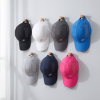 Running cap in seven colours hanging on wall pegs