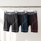 The padded cycling liner shorts in grey, blue and red hanging on a clothes rail