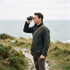 Walker using the 10x50 monocular one handed on a British coastal path