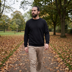 Man wearing black sherpa-lined crew neck jumper walking in autumn British park