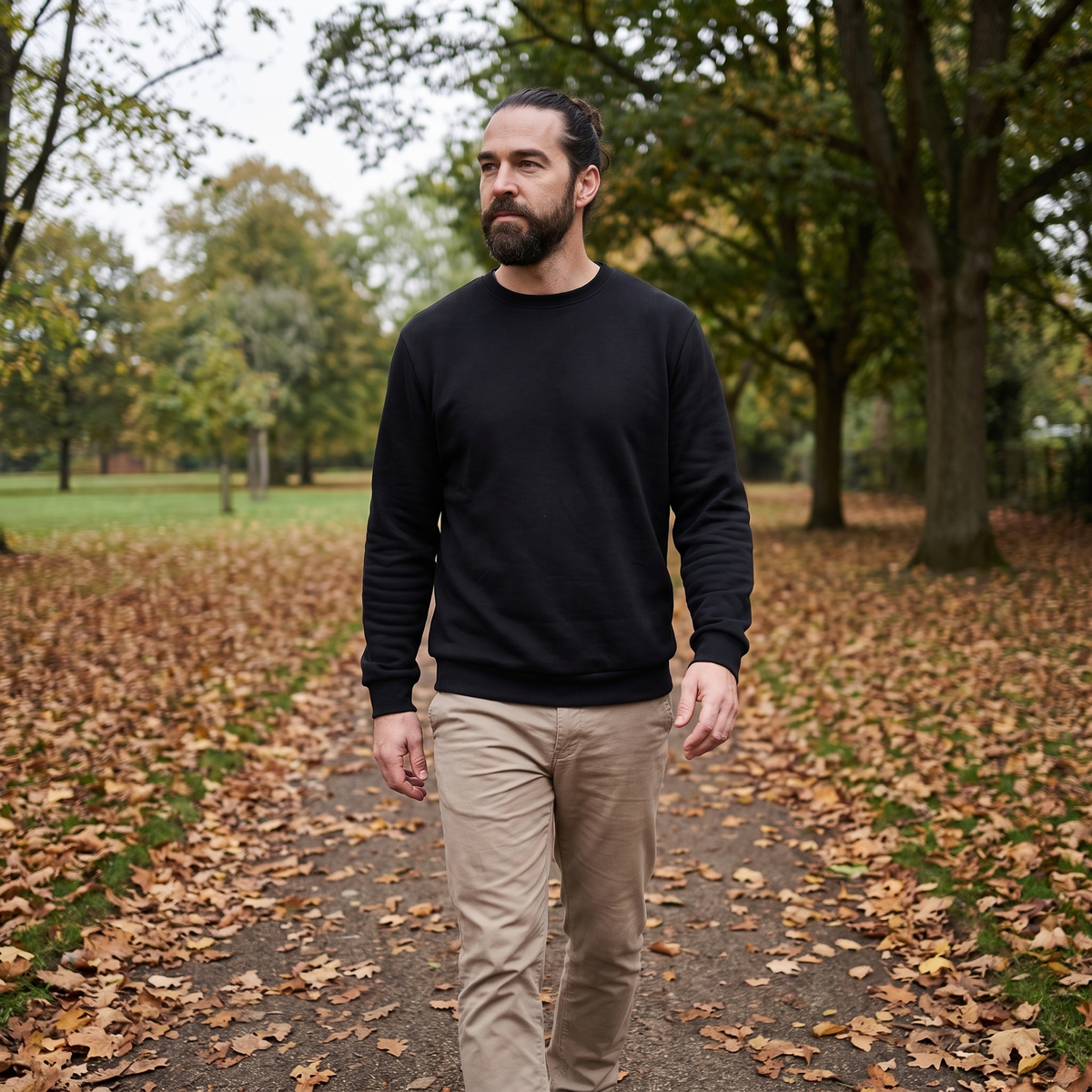 Man wearing black sherpa-lined crew neck jumper walking in autumn British park