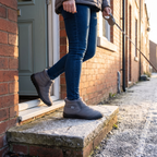 Women's slip-on snow boots worn stepping out of a front door on a frosty morning in Britain