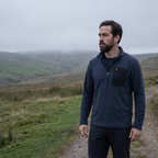 Man wearing the quarter zip fleece on an overcast moorland path