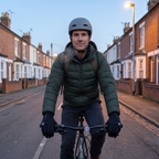 Man cycling to work on a terraced street in England on a winter morning, gloves on