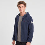 Men's navy blue windproof fleece jacket worn, three-quarter view