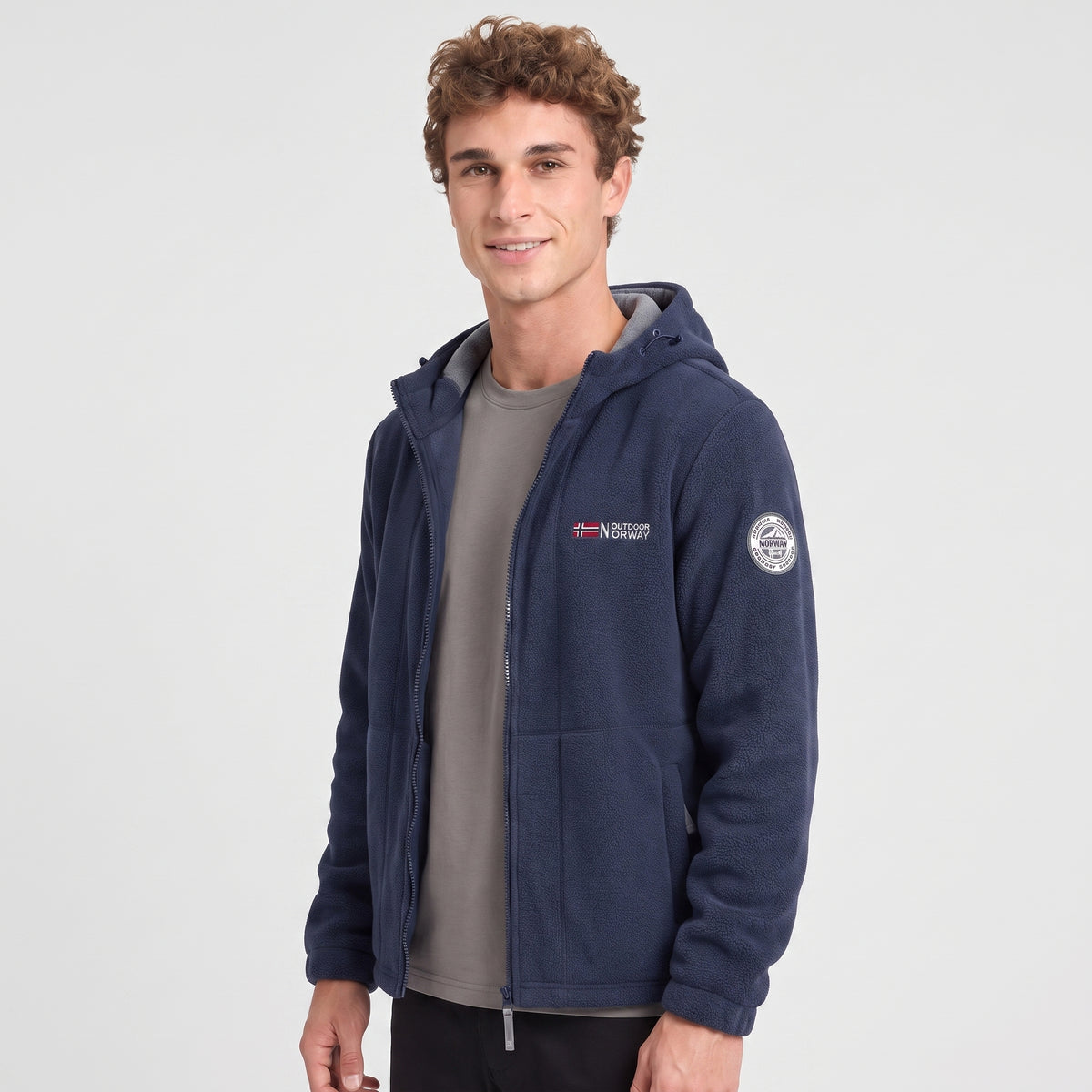 Men's navy blue windproof fleece jacket worn, three-quarter view