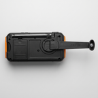 Back of the wind up radio with antenna, AAA battery compartment and hand crank