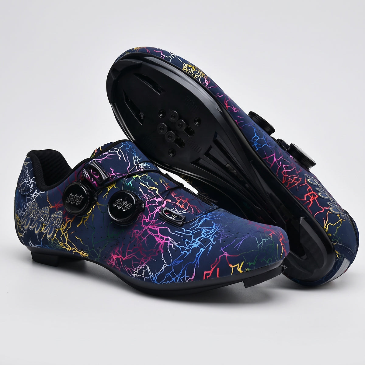 Dark Blue cycling shoes with road soles, a pair with one sole turned up to show the cleat holes