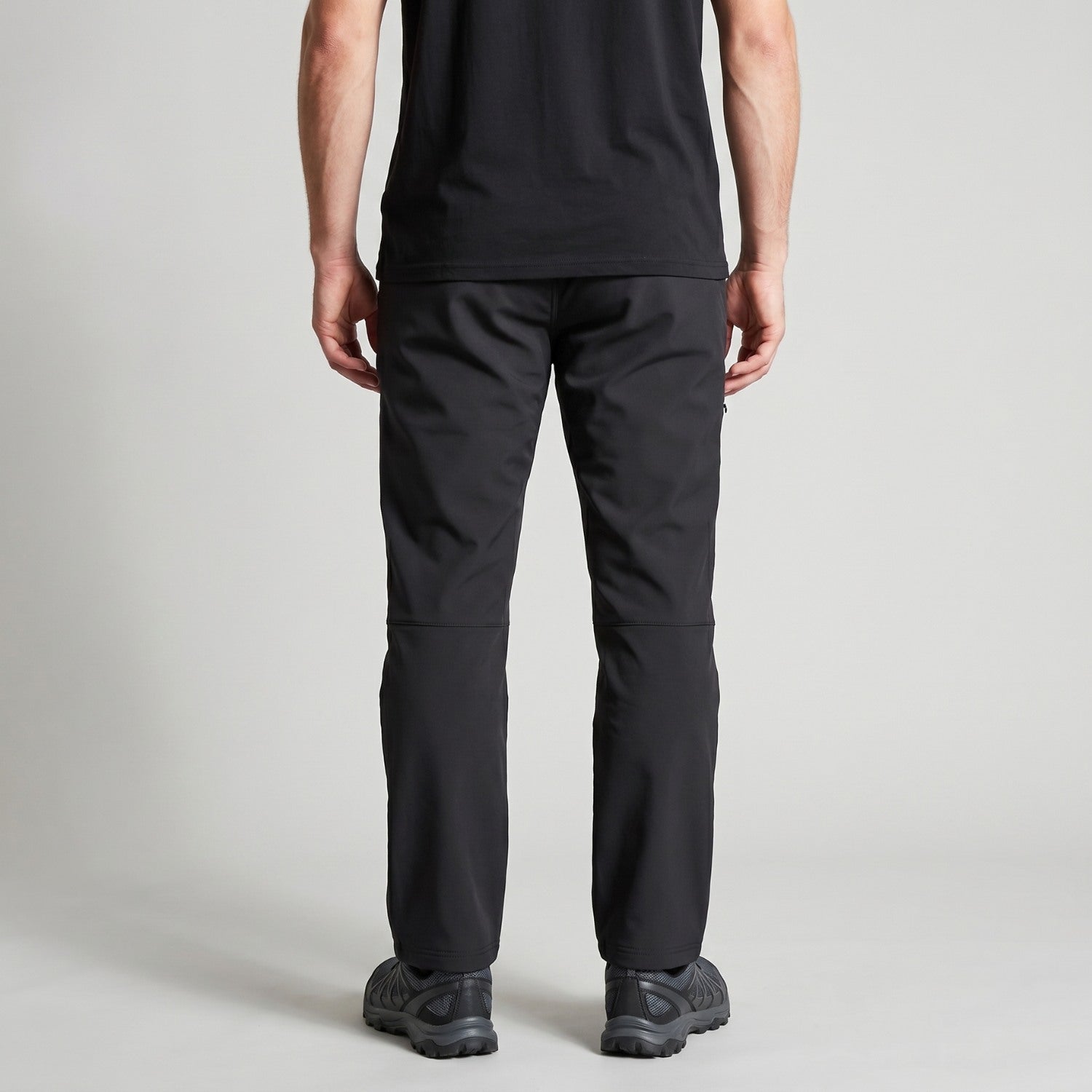 Men's black walking trousers worn, back view