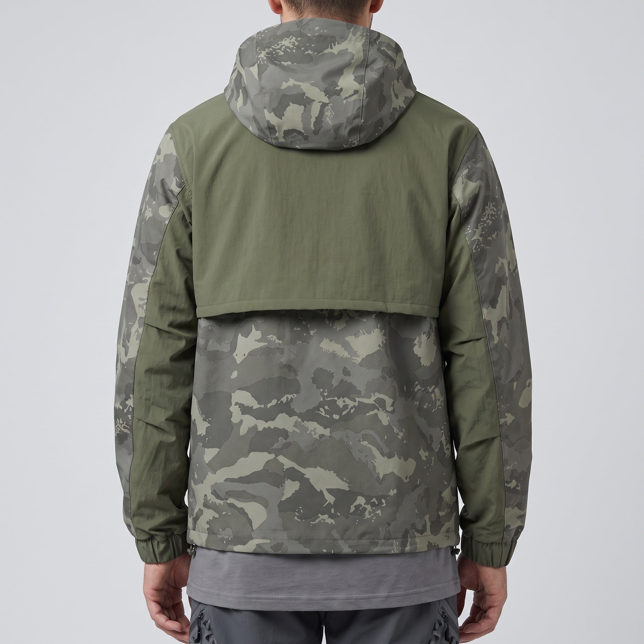 Camo anorak worn from behind showing the storm-cape back yoke